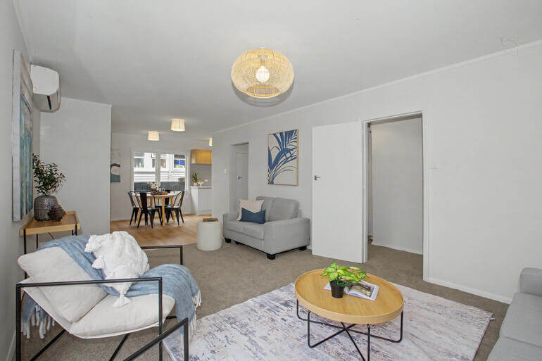 Before-and-after AI-edited real estate photo showing a living room transformed from dark and dim to bright and inviting.