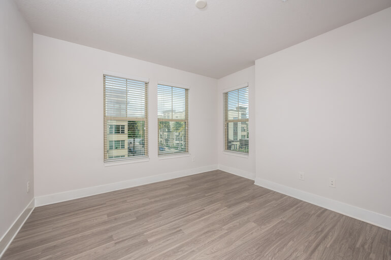 Before and after AI virtual staging of an empty bedroom transformed into a fully furnished, listing-ready space.
