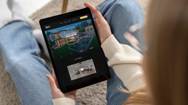 Person viewing a dedicated single property website on a tablet