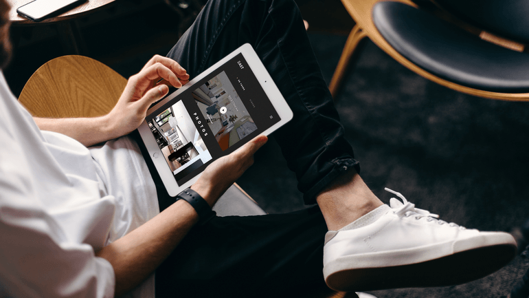 Person viewing a mobile-optimized single property website on a tablet