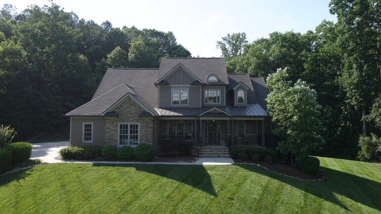 Before and after comparison of a house exterior demonstrating AI real estate photo editing.