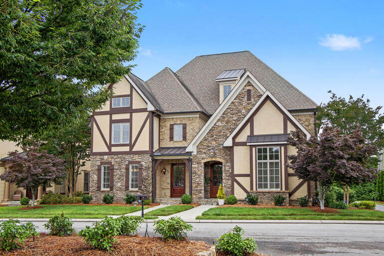 Before and after comparison of a house exterior demonstrating AI real estate photo editing.