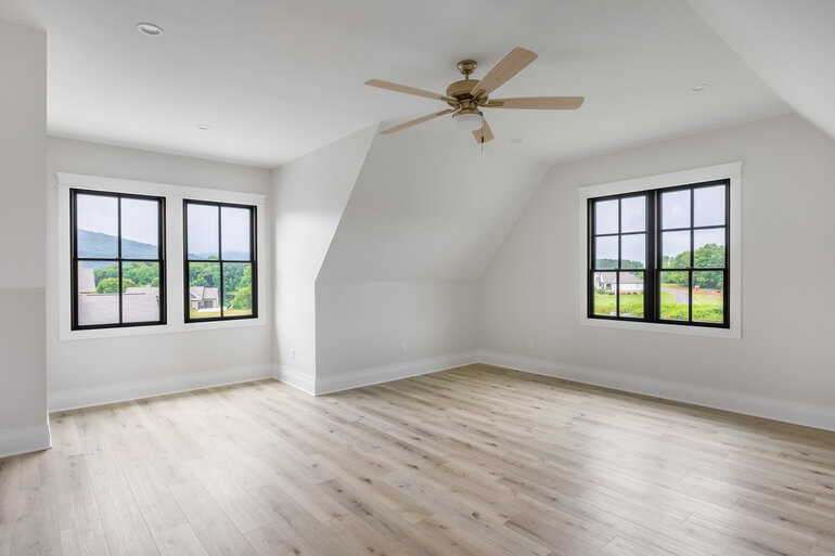 Photograph of an empty, unfurnished room in a real estate listing.