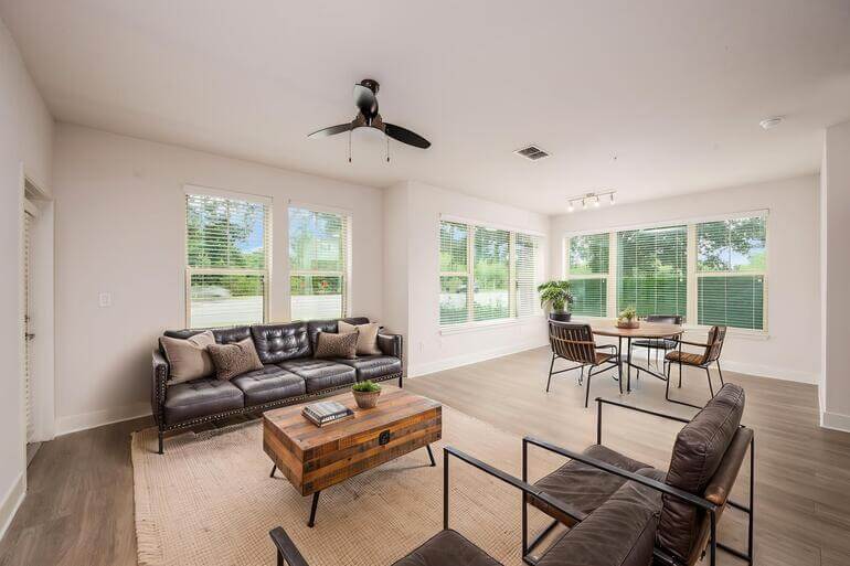 Side-by-side comparison of an empty living room and the same space AI virtually staged with furniture.