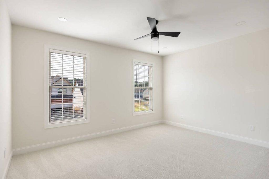 AI photo editing for real estate improves an empty bedroom.