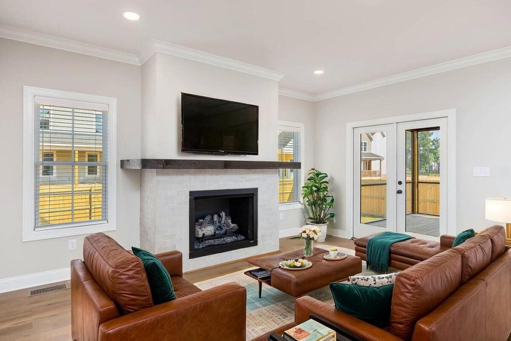 Modern living room staged with a green sectional sofa and contemporary décor.