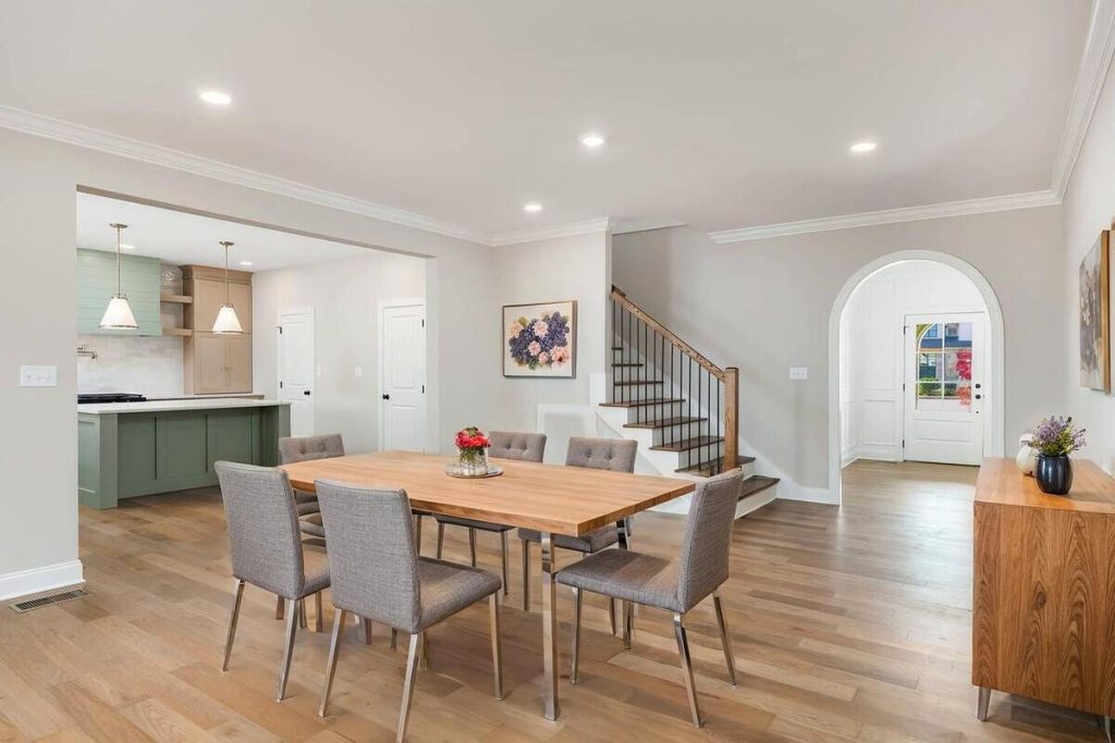 AI virtual staging transforms an empty dining space with a modern wood dining set.