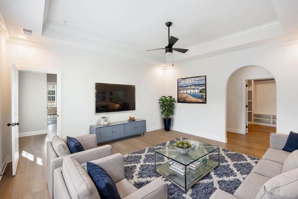 AI-staged living room featuring a media console, TV, and neutral furnishings.