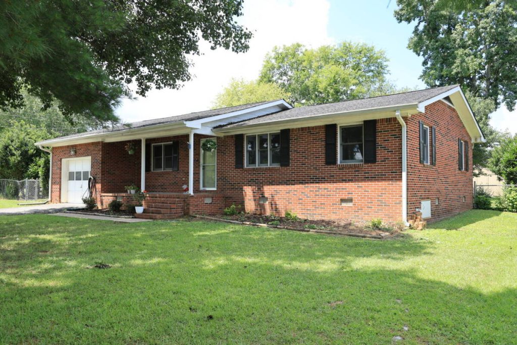 Before photo editing for real estate agents on a brick home
