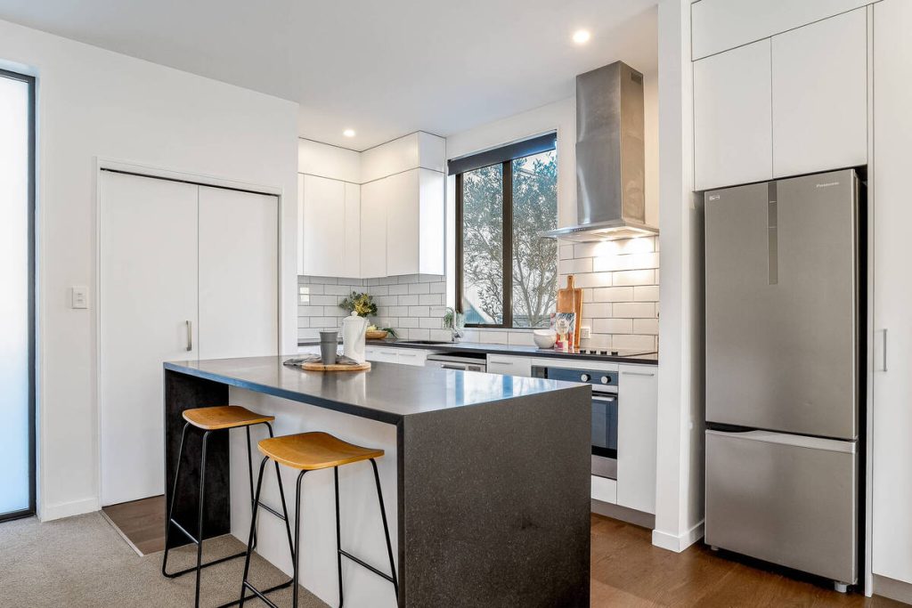 Modern kitchen enhanced using real estate photo editing AI.