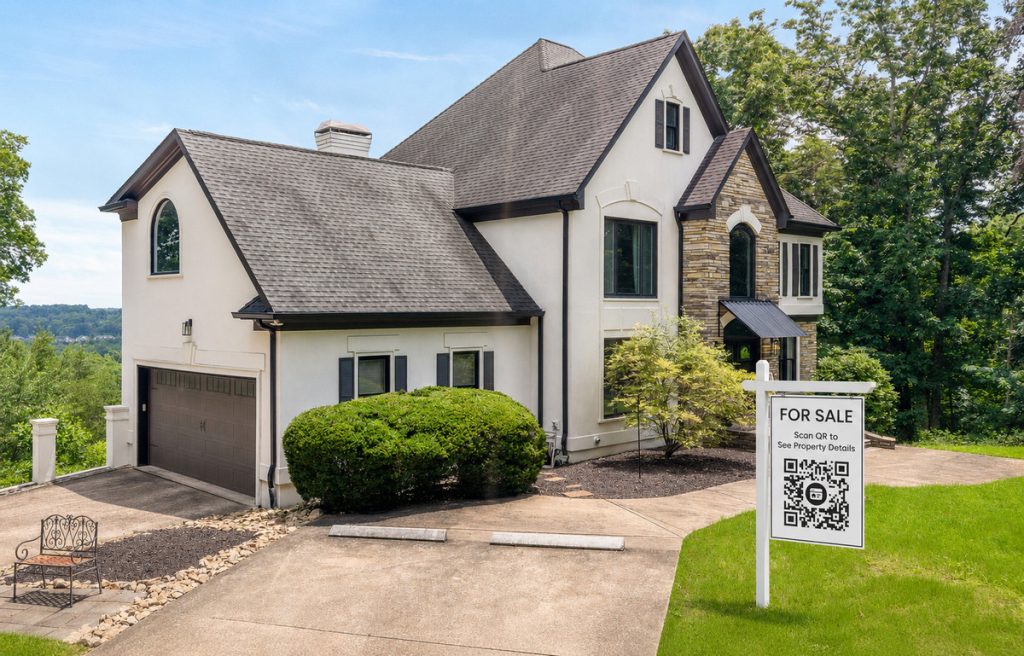 For Sale yard sign with QR code linking to a real estate website