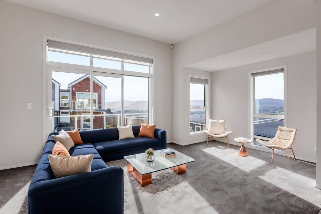 Best AI virtual staging example featuring a navy sectional and modern furniture.