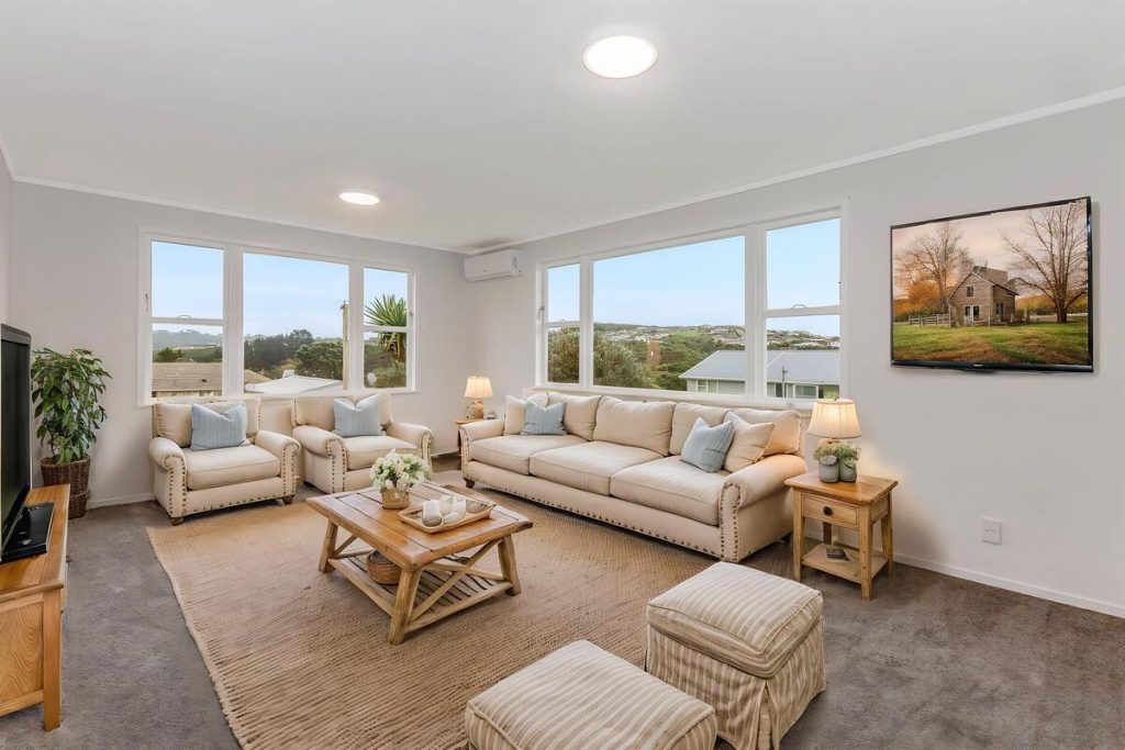 Best AI virtual staging example of a bright living room with neutral furniture and natural decor.