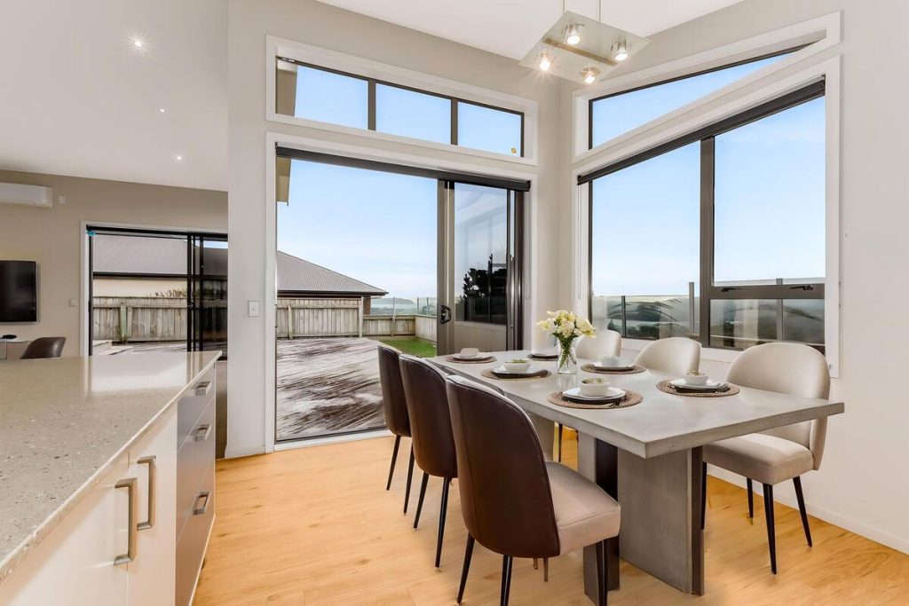 Best AI virtual staging example featuring a modern dining table with neutral chairs.