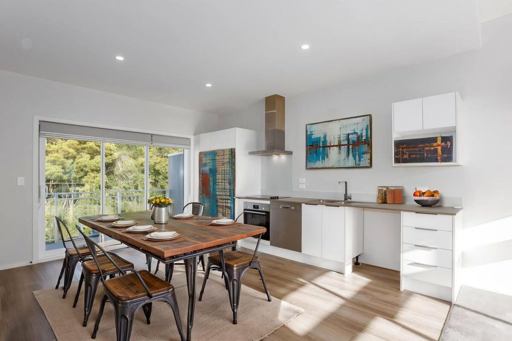 Best AI virtual staging example of a dining area with a wood table and brown leather chairs.