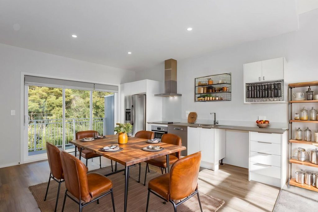 Best AI virtual staging example featuring a large wood dining table with neutral chairs.