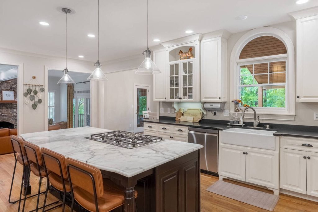 AI real estate photo editing showcasing a bright white kitchen with balanced lighting and clear details.