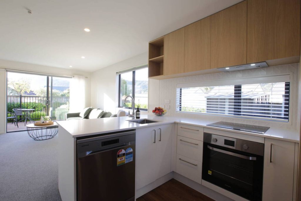 Modern kitchen before AI real estate photo editing removal and cleanup.