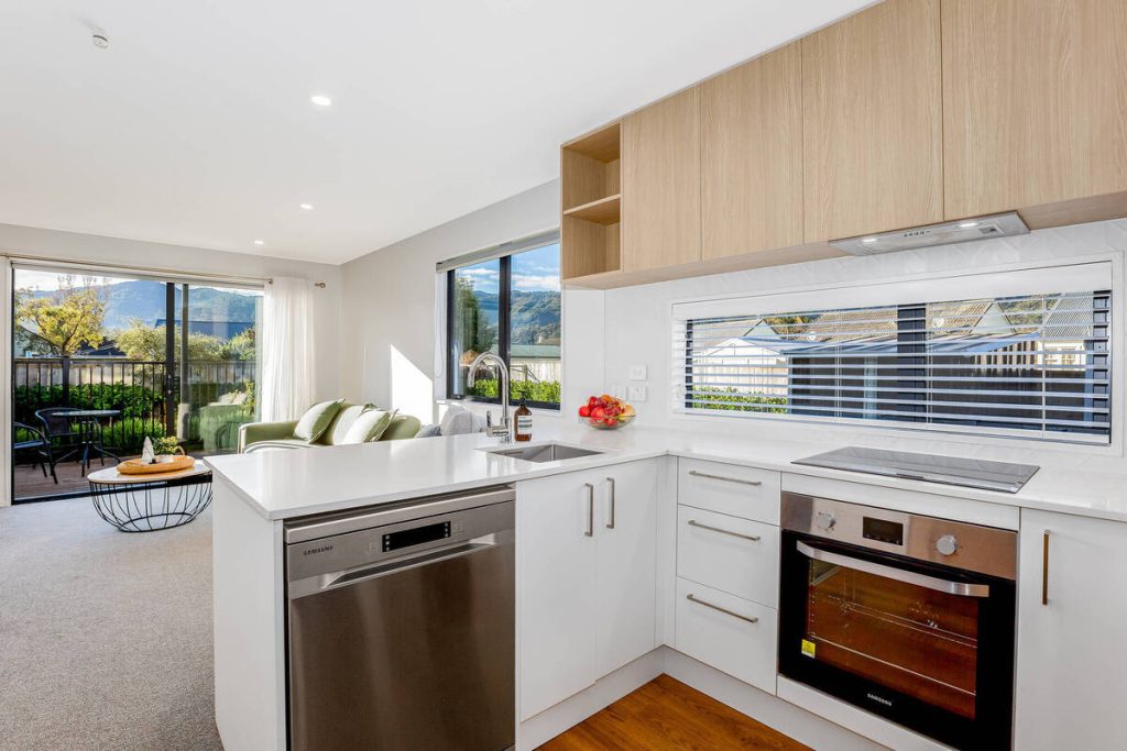 Modern kitchen after AI real estate photo editing removal and cleanup.