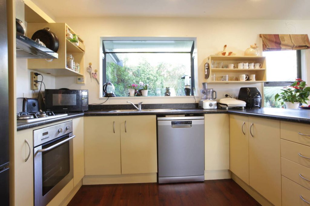 Kitchen before AI real estate photo editing removal of distracting items.