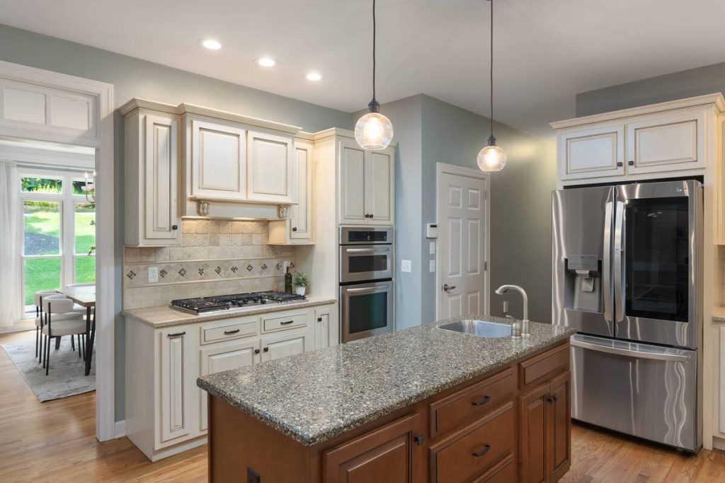 AI real estate photo editing showcasing stainless steel appliances and a spacious kitchen island.