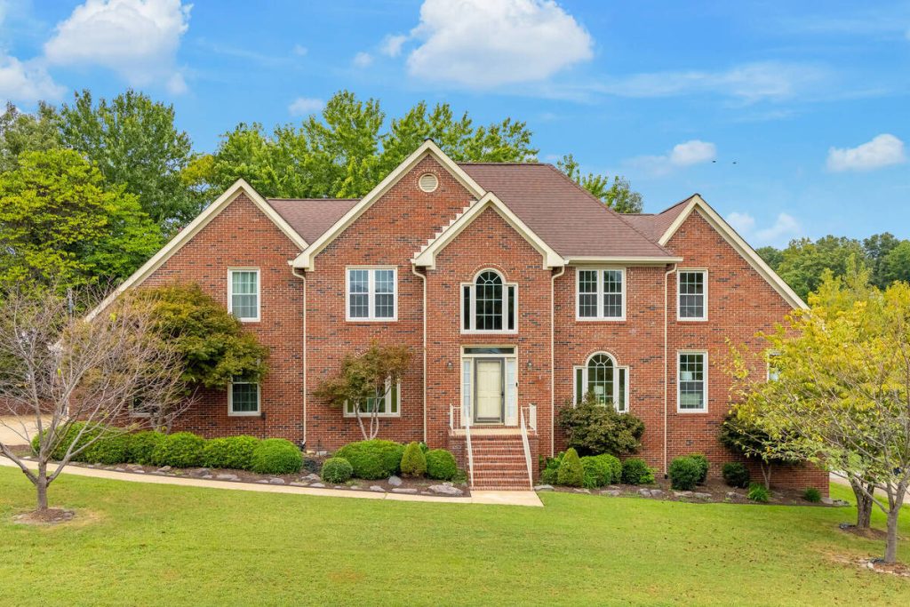 Real estate photo editor showcasing a bright brick house exterior
