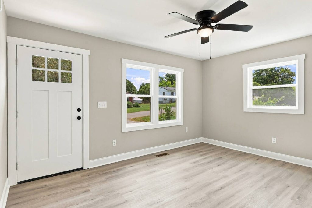 Real estate photo editor showing an empty living room before virtual staging