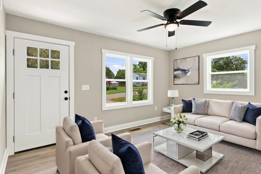 Real estate photo editor creating a bright virtually staged living room