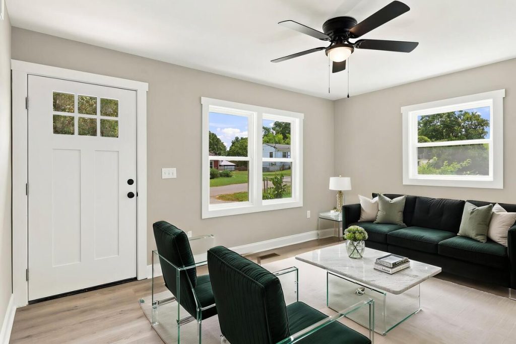 Real estate photo editor adding modern virtual staging to an empty room