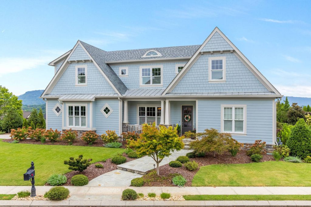 Real estate photo editor enhancing the sky, lighting, and color of a home exterior