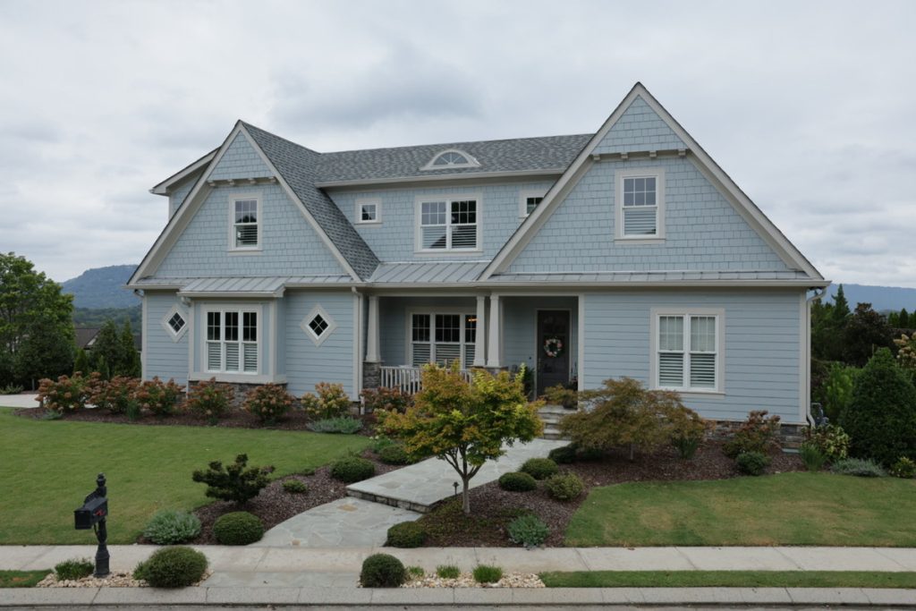 Real estate photo editor showing a home exterior before photo enhancement
