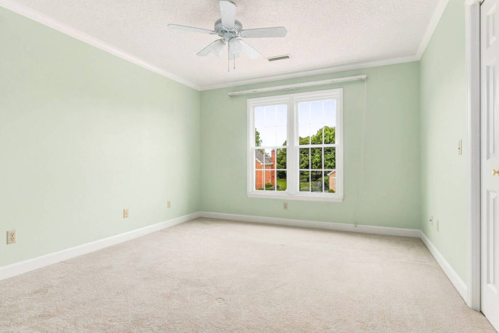 Real estate image editing showing an empty bedroom prepared for virtual staging
