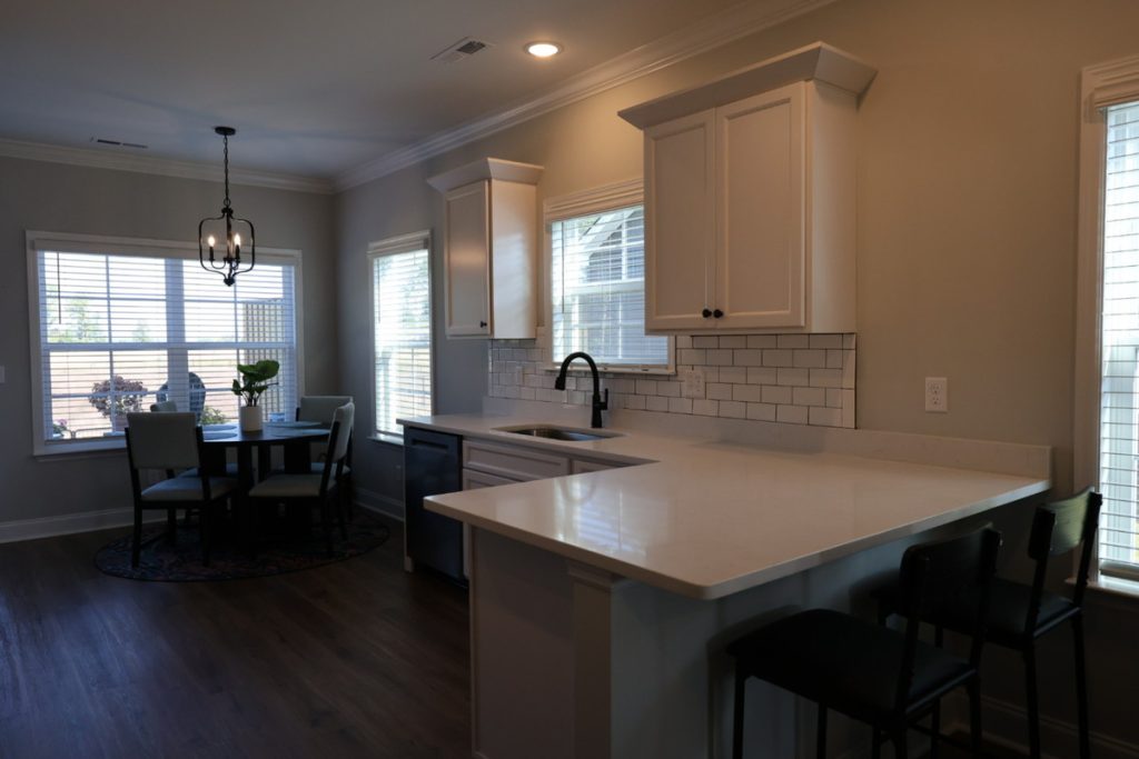 Real estate image editing example of a dark kitchen before exposure correction