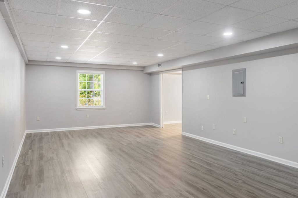 Real estate image editing showing a clean and bright empty basement room