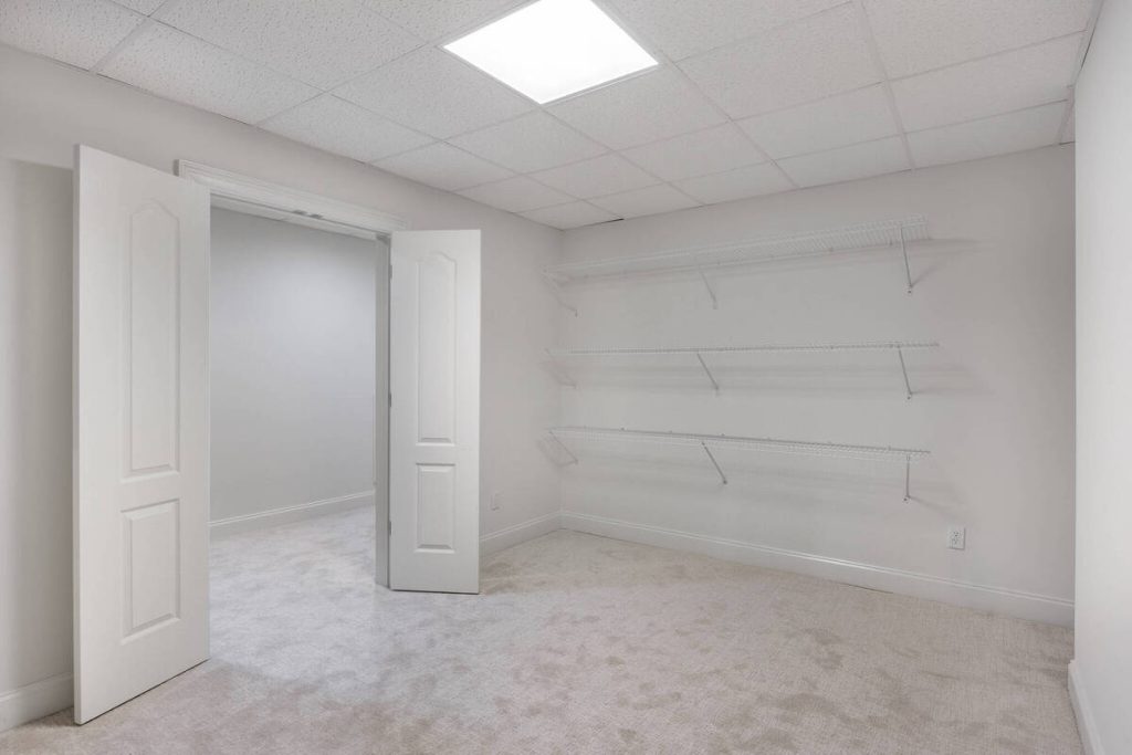 Empty walk-in closet showing a low-priority room for virtual staging software.