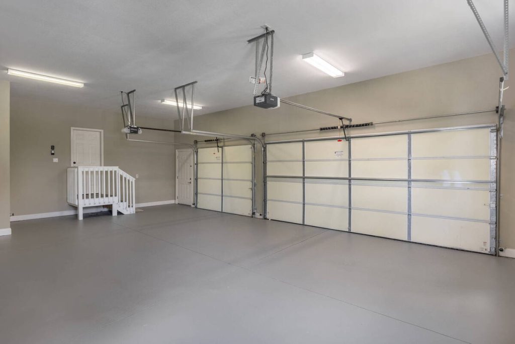 Spacious three-car garage showing a room that may not need virtual staging software.