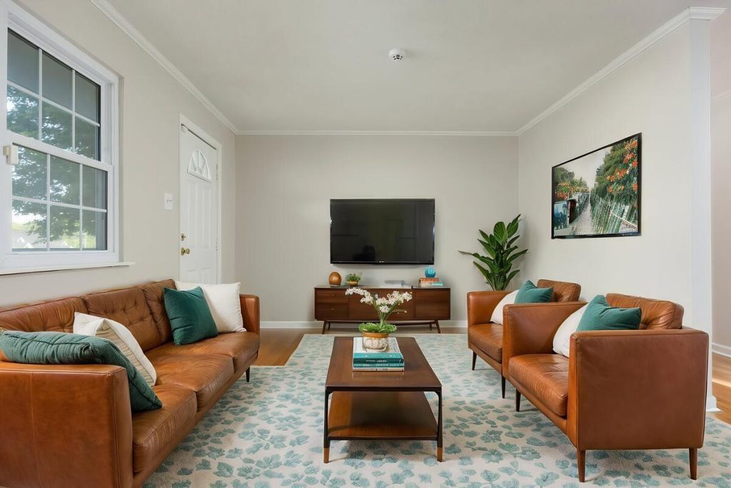 Living room with leather seating and modern decor created using virtual staging software.