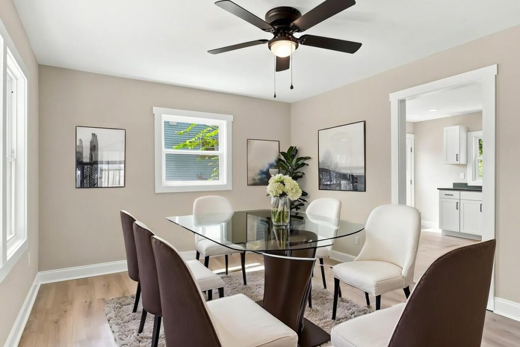 Dining room with glass table and modern seating created using virtual staging software.