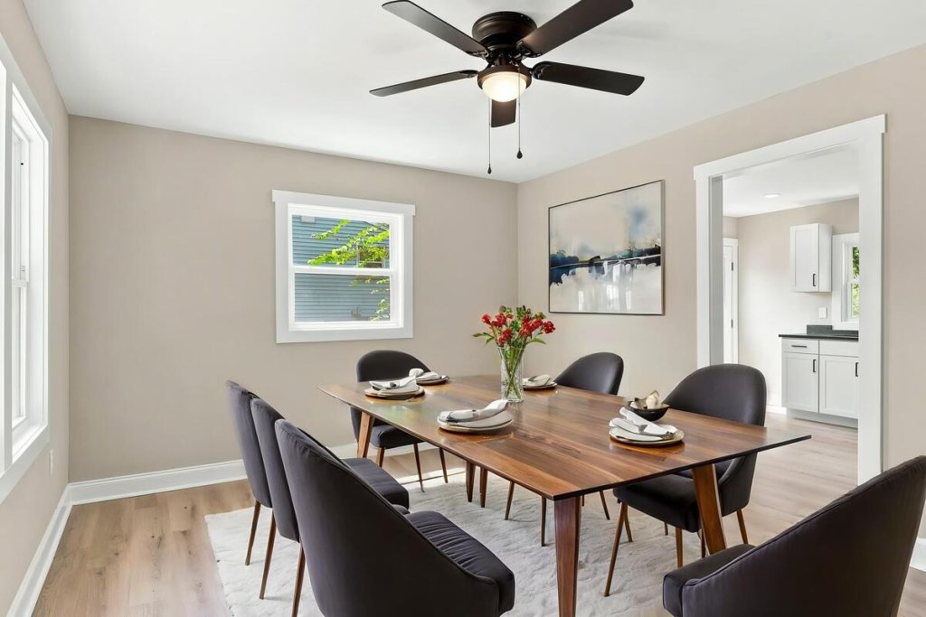 Virtually staged dining room with wood table and dark chairs using virtual staging software.