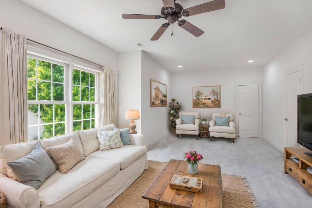 Bright family room furnished with seating and decor using virtual staging software.