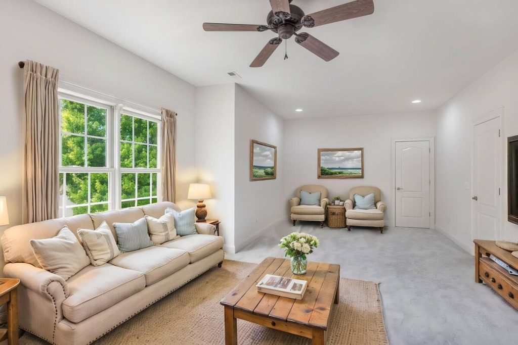 Alternative family room layout with neutral furniture created using virtual staging software.