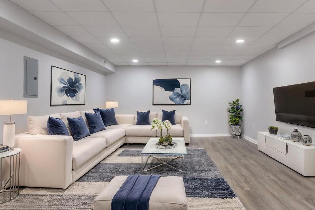 Modern lounge with sofa and TV created using virtual staging software.